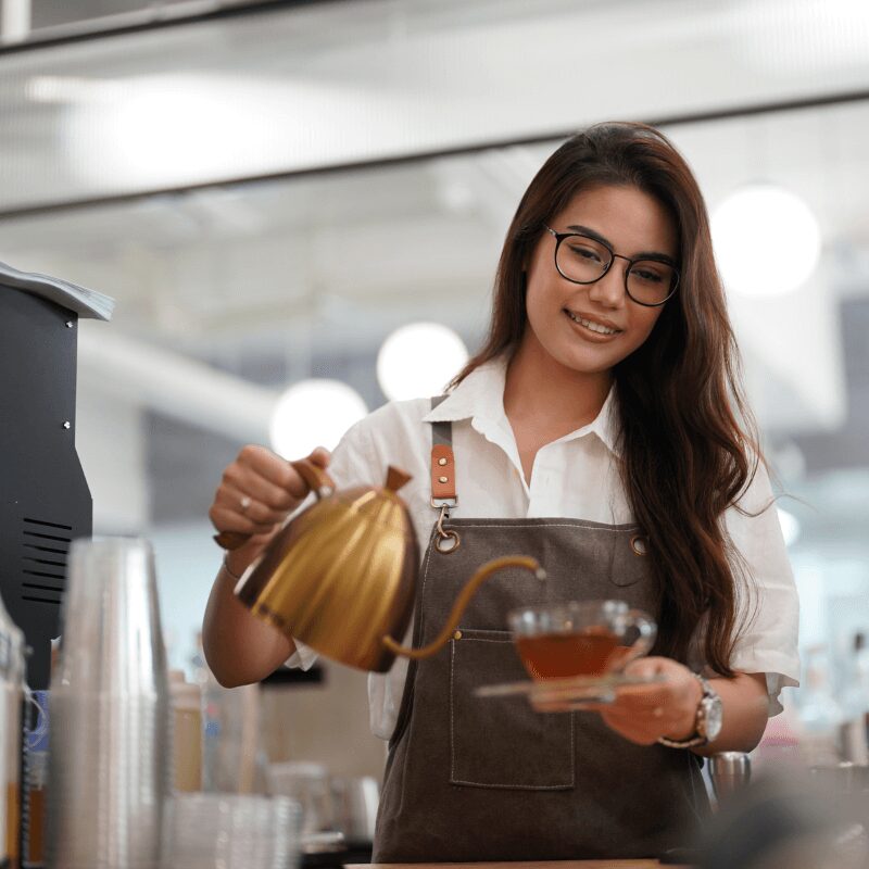 barista making coffee in a cafe